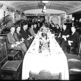 A group of men around a long lavishly set dining table, former Wentworth Hotel, Lang Street Sydney.