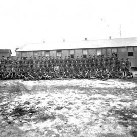 Regiment of soldiers outside barracks, unknown location, circa 1916