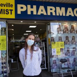 Erskineville Pharmacy employee with Covid-19 signage, Erskineville Road Erskineville, 2021