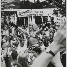 Drag queen Shuvon is lifted above crowd at rally in Kings Cross, 1991