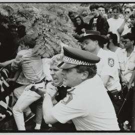 Protester and police officer struggle, Kings Cross, 1990