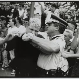 Protester and police officer struggle, Kings Cross, 1990