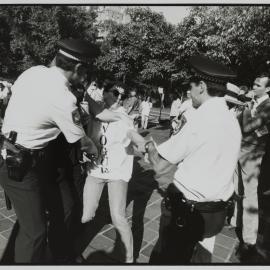 Police officers grab protester, Kings Cross, 1990