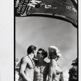 Kiss under the Mardi Gras Fair Day banner, Jubilee Park Glebe, 1993