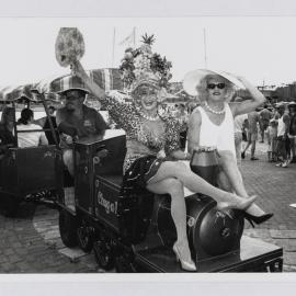 Miss Fair Day runners-up on a miniature train, Mardi Gras Fair Day, Jubilee Park Glebe, 1997