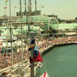 Man at top of mast, boat at Darling Harbour, Bicentenary, 1988