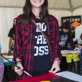 Girl painting an Aboriginal flag, NAIDOC In The City, Hyde Park, 2014