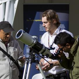 Using the telescope at the Sydney Observatory stall, NAIDOC In The City, Hyde Park, 2014
