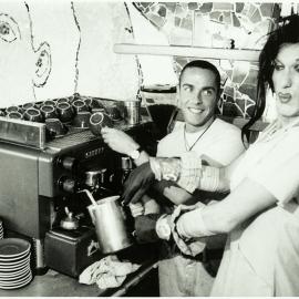 Baz and drag queen Cindy Pastel work as baristas at an unknown cafe, 1995