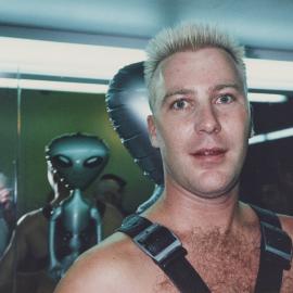 PRIDE party performer with photographer Jamie Dunbar in mirror, 2000