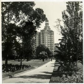 View of T&G Building through trees in Hyde Park North, Sydney, circa 1937-1938