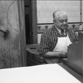 Butcher at the till, Chris Yianni butchers, Chalmers Street Redfern, 1983
