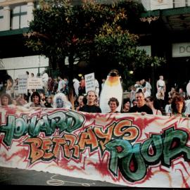 Social justice group hold up their banner 'Howard Betrays Poor', nd