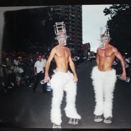 Two buff men wearing wild costumes, pre Mardi Gras parade, nd