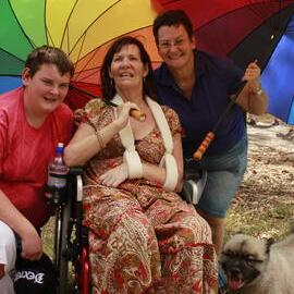 Woman in wheelchair, her son and partner, Victoria Park, Mardi Gras Fair Day, 2011