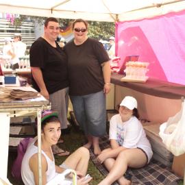 Lesbians behind their stall with family, Victoria Park, Mardi Gras Fair Day, 2012