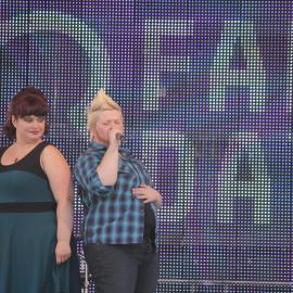 Drag King and girlfriend singing on stage, Victoria Park, Mardi Gras Fair Day, 2012
