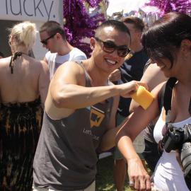 Man giving temp tattoo to woman, Victoria Park, Mardi Gras Fair Day, 2012