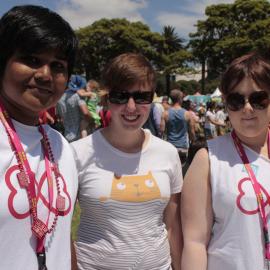 Lesbian volunteers sport their current Mardi Gras t-shirts, Victoria Park, Mardi Gras Fair Day, 2012