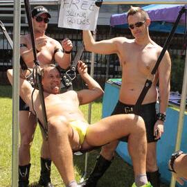 Testing the free sling ride, Leather Pride group stall, Victoria Park, Mardi Gras Fair Day, 2012