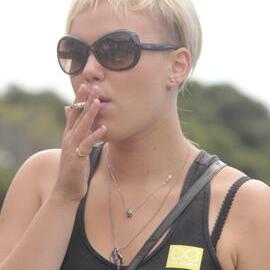Young woman smoking, Victoria Park, Mardi Gras Fair Day, 2012