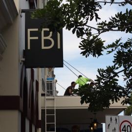 Workmen on awning roof, FBI, Glebe Point Road, Glebe, 2012