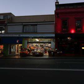 Night time on Glebe Point Road, red lights on awning, Glebe, 2018