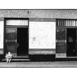 Child on steps of pub