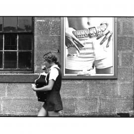 Girl walking past adversitement