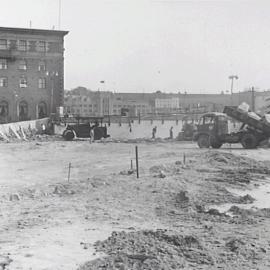 View of trucks clearing rocks