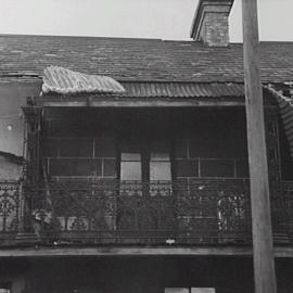 Front façade of a terrace with damaged roof, Caroline Street Redfern, 1952