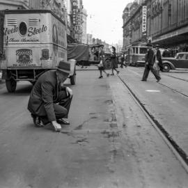 Street undergoing road inspection, near corner of Market and George Street Sydney, 1940s