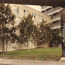 Graffiti on wall next to Eastern Suburbs Railway pylons, Sir John Young Crescent Woolloomooloo, 1980s