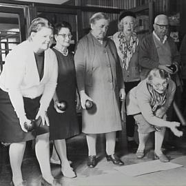 Pensioners play indoor bowls