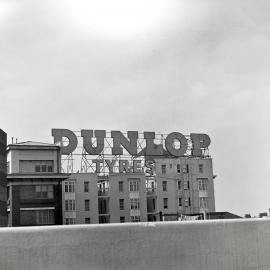 Dunlop Tyres top hamper advertising sign, Victoria Street Darlinghurst, 1959