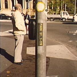 Pedestrian signal button on pole