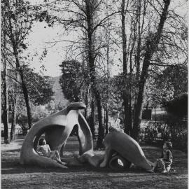 Children playing on Earth Mother sculpture in Phillip Park, College Street Sydney, circa 1960s