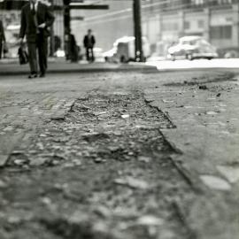 Damaged road surface, George Street and Quay Street Sydney, 1956