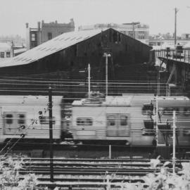 Train passing under railway bridge