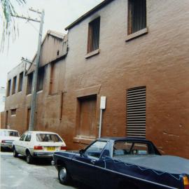 View looking south-west to warehouse and parked cars, 30 William Street Redfern, 1989