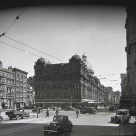 Queen Victoria Building (QVB) with traffic along nearby streets, 1940's