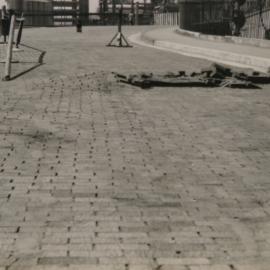 Damage to wooden blocks in road surface