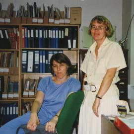 Archivistst Angela McGing and Gunnell Bellviken