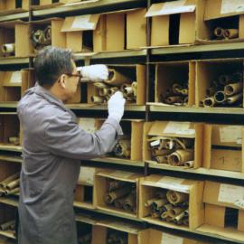 Archivist Renato Perdon with boxes of building plans