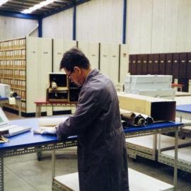 Archivist Renato Perdon working on the Building Plans reboxing project