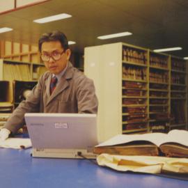 Archivist working on the Building Plans re-boxing project, 1996