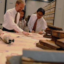 Archives staff examining records