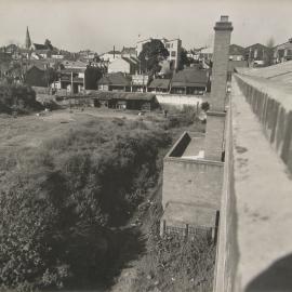 View looking south east over vacant land from warehouse towards Hereford Street Glebe, 1956