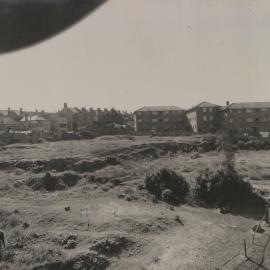 View across vacant land looking from Hereford Street towards Wigram Lane Glebe, 1956