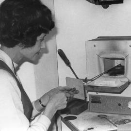 Lois Sabine demonstrating vitreous enameling using a kiln, 1970